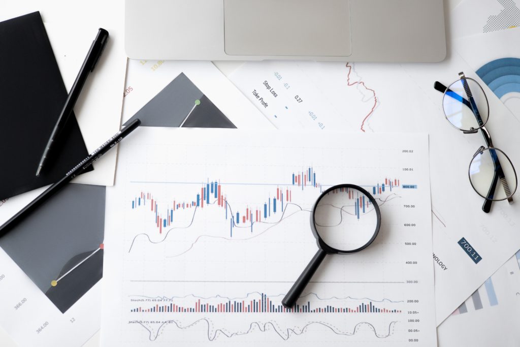 A magnifying glass sitting on some graphs.